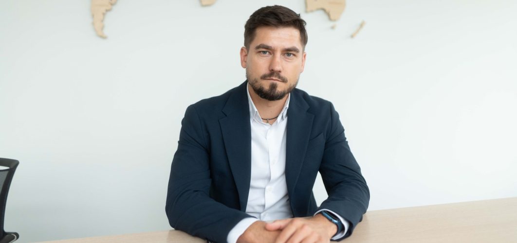 Artis Pukitis, CEO of Hive5, seated at a desk in the Ruptela office.