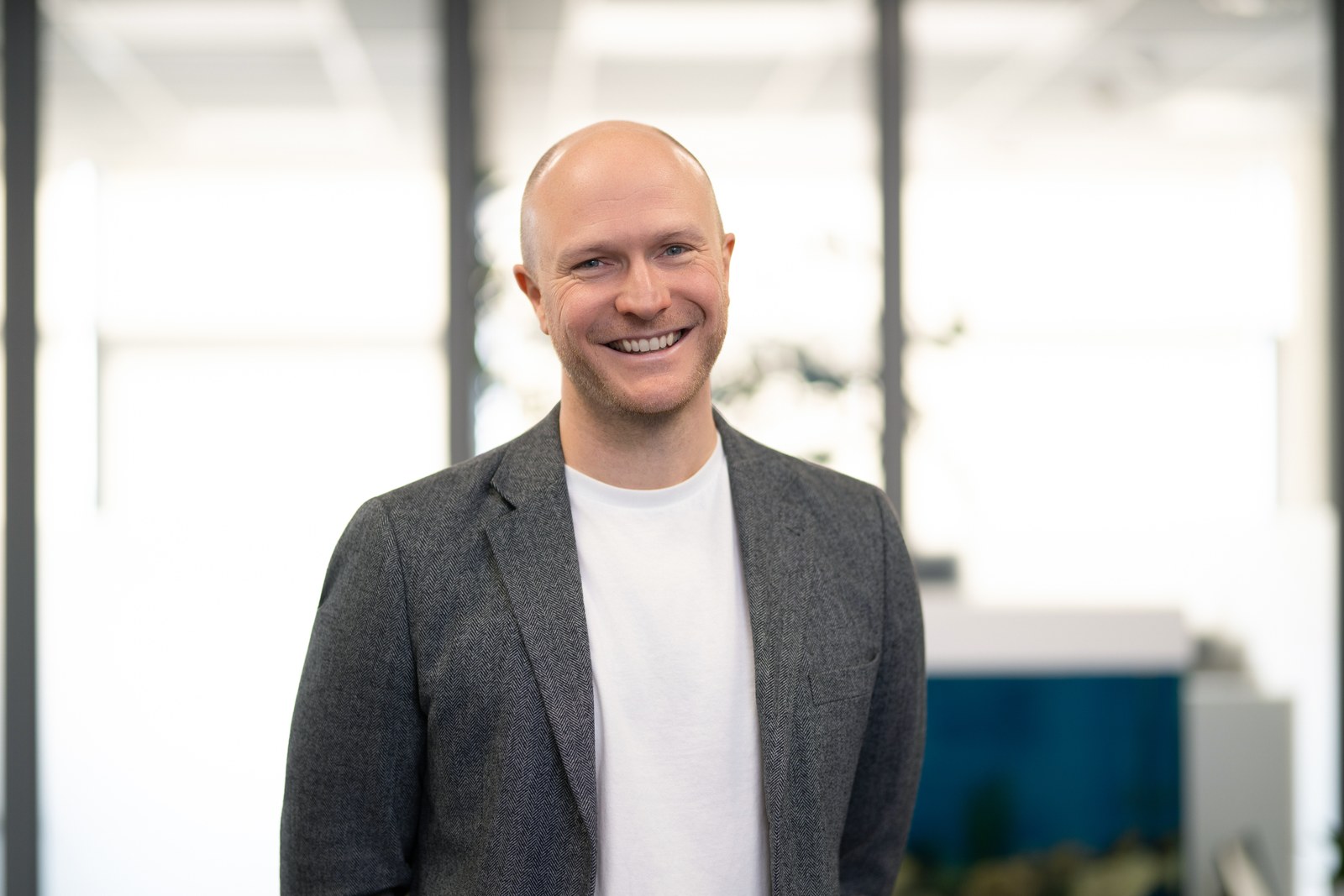 Krisjanis Znotins, CEO of Hive Finance Group, smiling in the office.